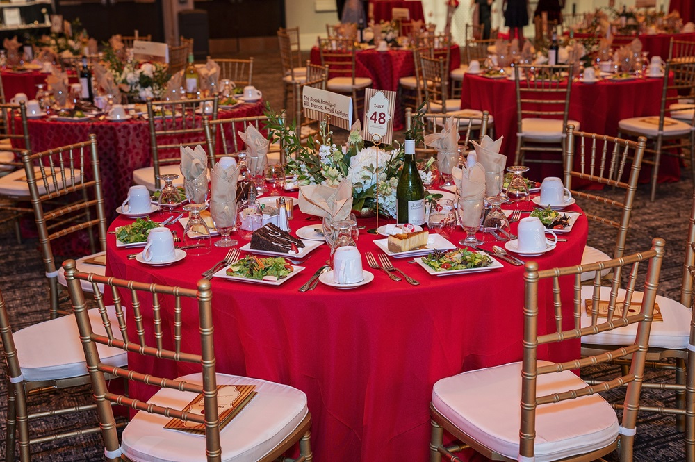 Fully set ballroom table.